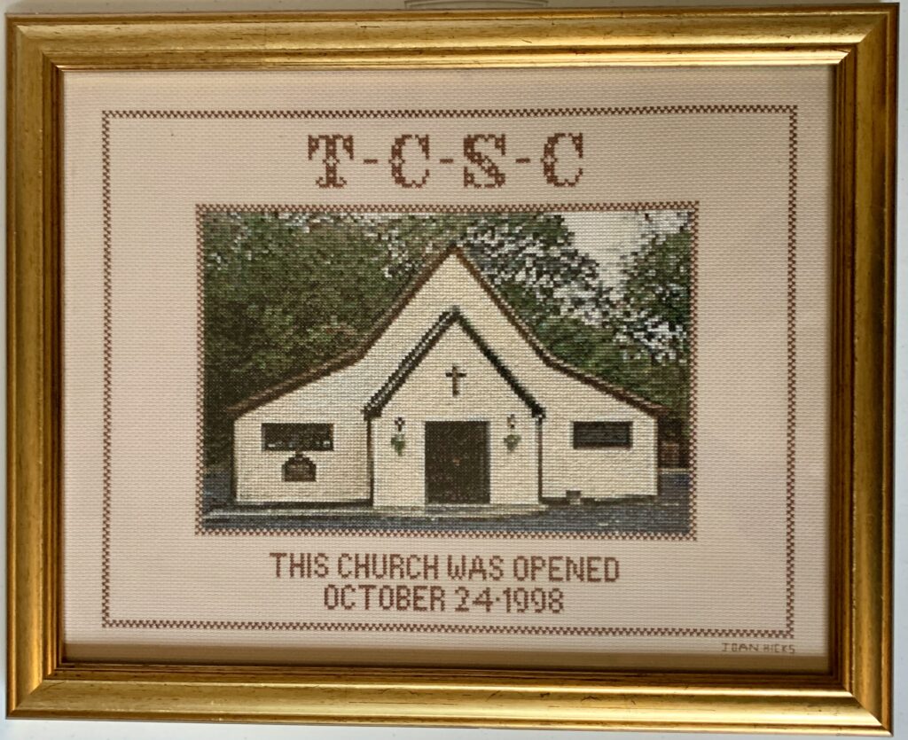 Cross-Stitch by Joan Hicks, wife of former present John Hicks.